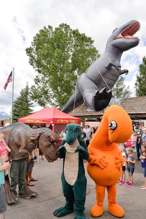 25 foot inflatable tyrannosaurus rex (t-rex) atop a building at a dinosaur convention