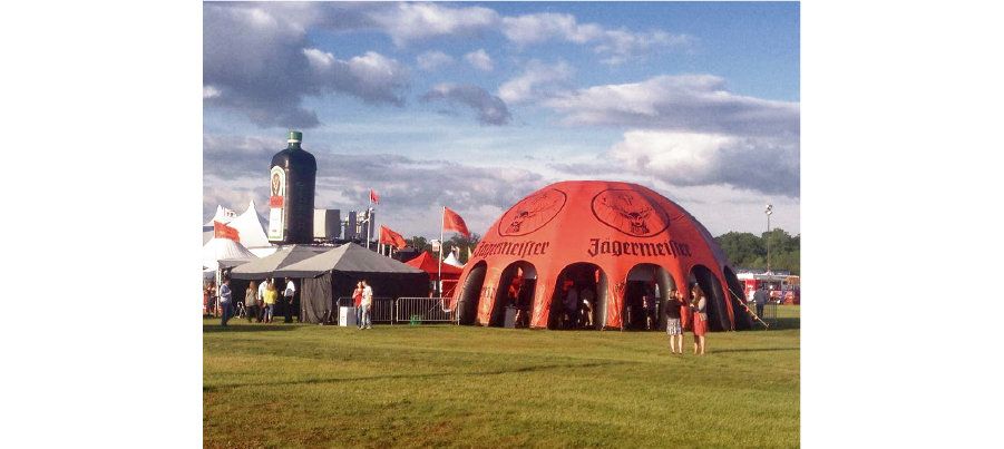 orange jagermeister inflatable dome at a music festival