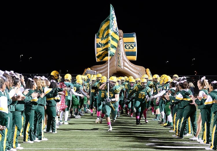 custom viking tunnel with a football team charging out of it at a high school football game