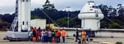 NASA space inflatable rocket and capsule installed at an event with multiple attendees standing next to it