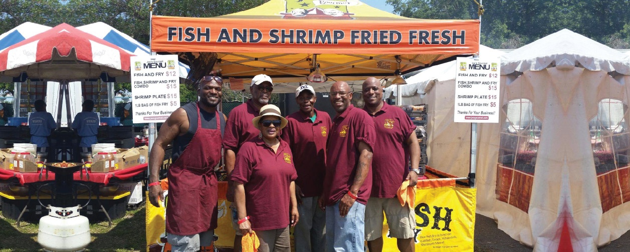 seafood food booth canopy with multiple chefs standing in front for a group photo of the team