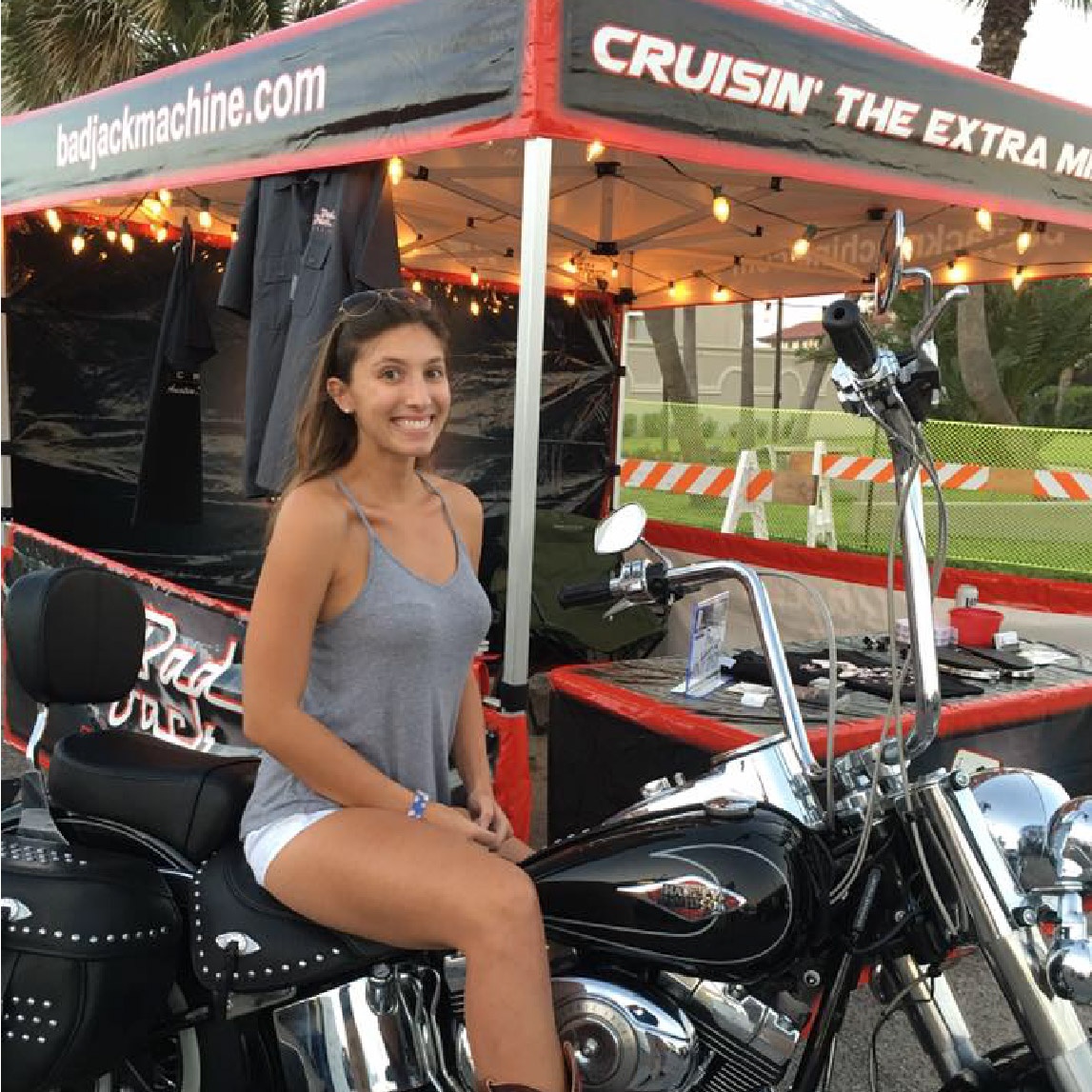 bad jack machine girl on motorcycle  next to a custom printed gold canopy package tent
