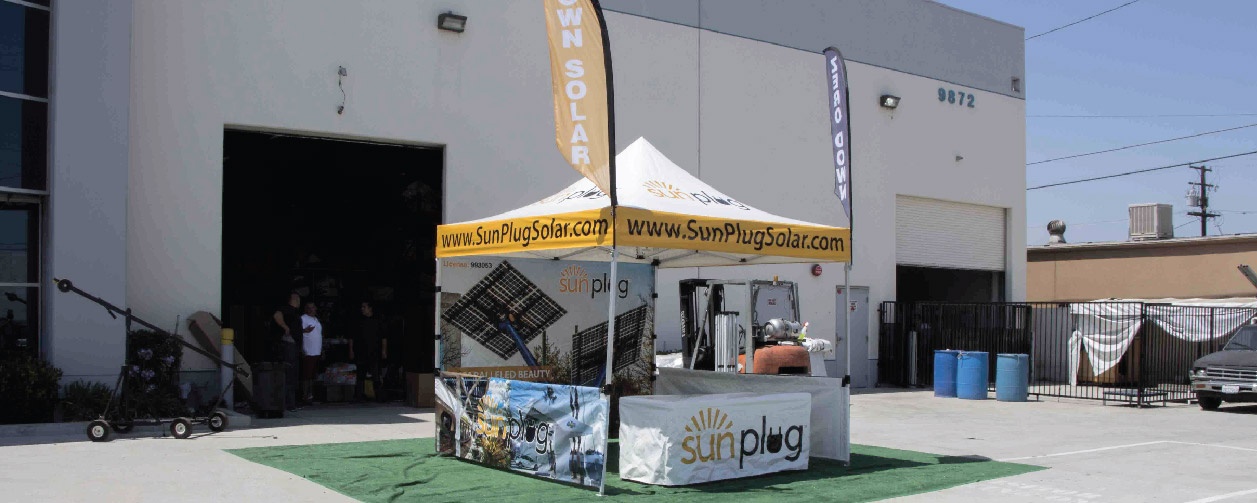 tent with printed canopy back wall, short walls, table cover, and advertising flags