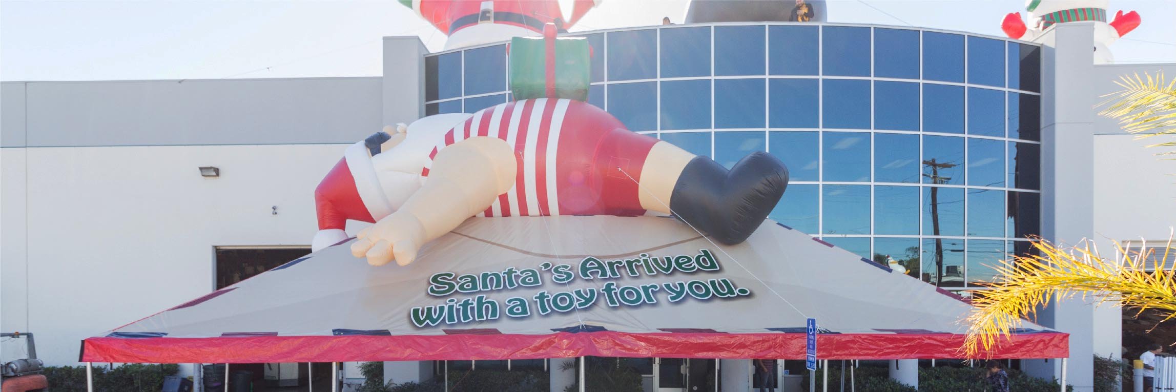 Lazy Santa Claus inflatable on tent in front of the Promotional Design Group building
