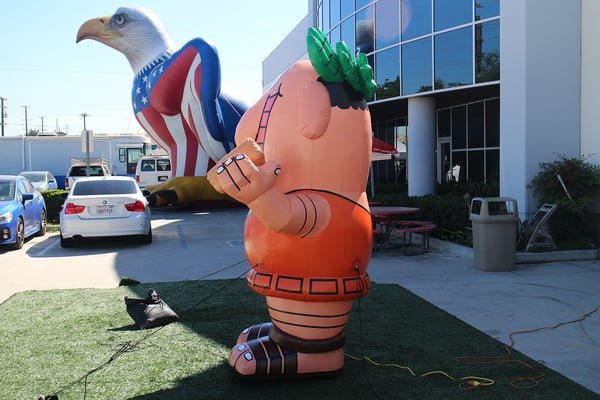 little-caesars-inflatable-character-replica-next-to-american-eagle