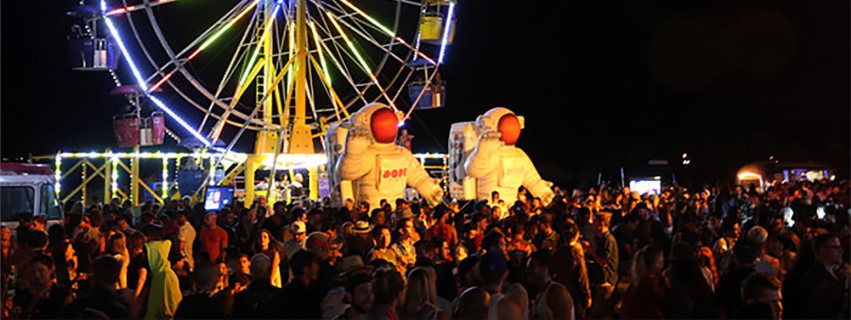 inflatable astronauts installed at a music festival as decorations