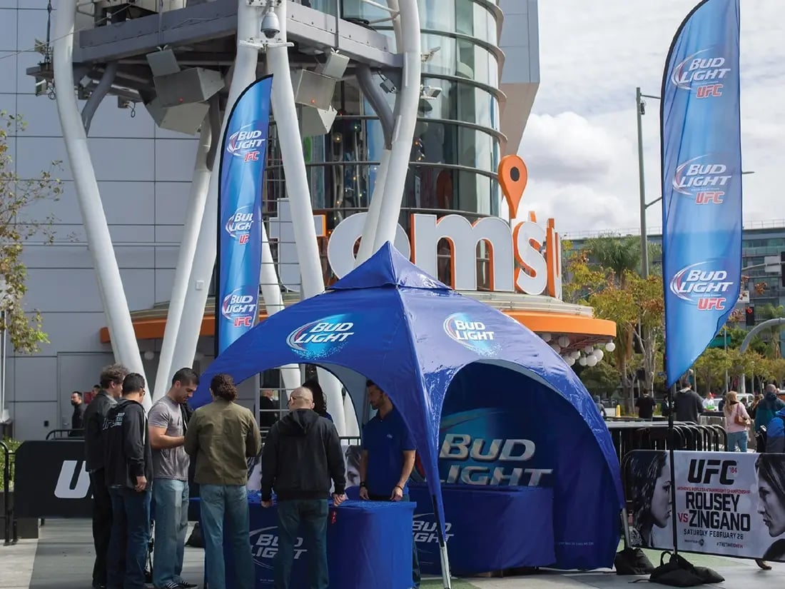 Bud Light inflatable dome tent used for a UFC fan event activation with branded flags and signage.