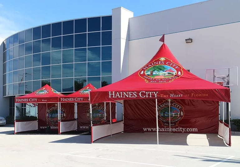 Haines City branded pop up canopies with printed back walls, roof logos, and website valance text