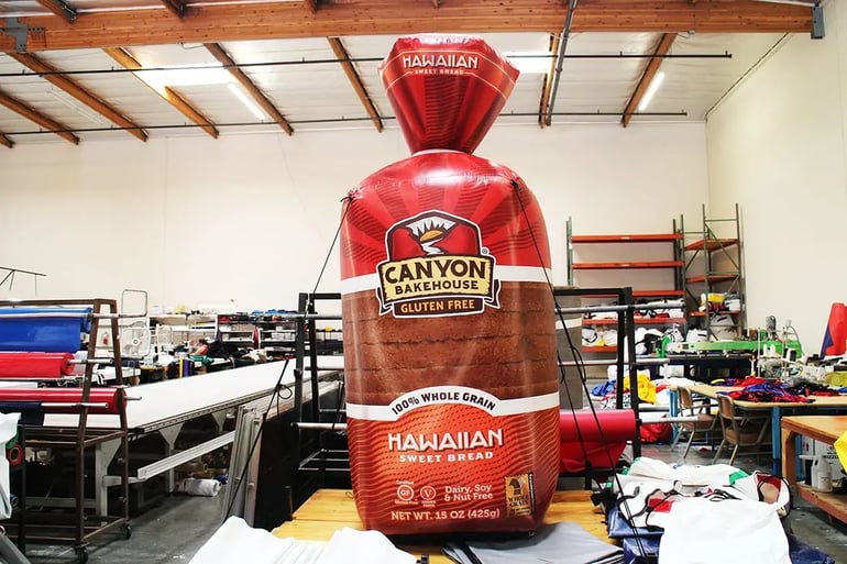 Front view of Canyon Bakehouse inflatable bread loaf replica with realistic print for event marketing
