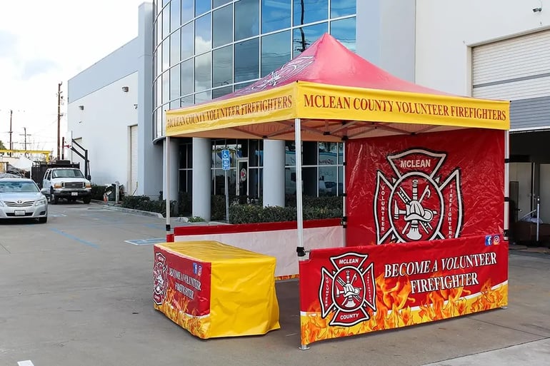 Custom pop up canopy with bold firefighter branding, printed rail skirts, and full back wall