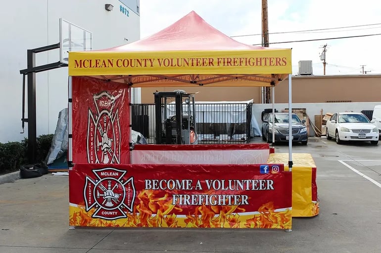 Custom printed pop up canopy booth with matching table cover and volunteer firefighter graphics