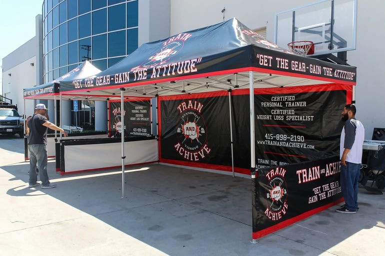 Custom 10x20 canopy booth with bold valance printing and full wall graphics for events