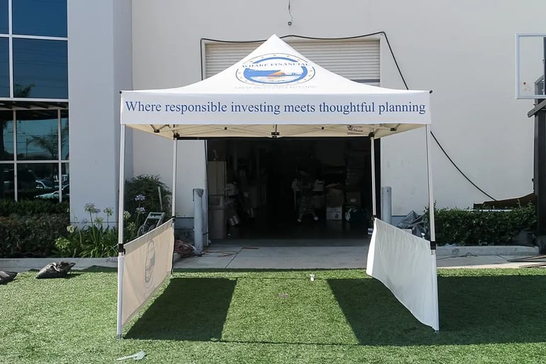 Branded pop up canopy with Wharf Financial roof logo and short side walls for event setup